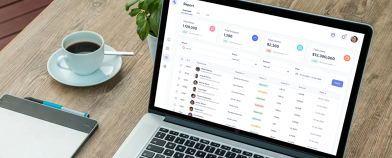 a laptop with the portal and a cup of coffee