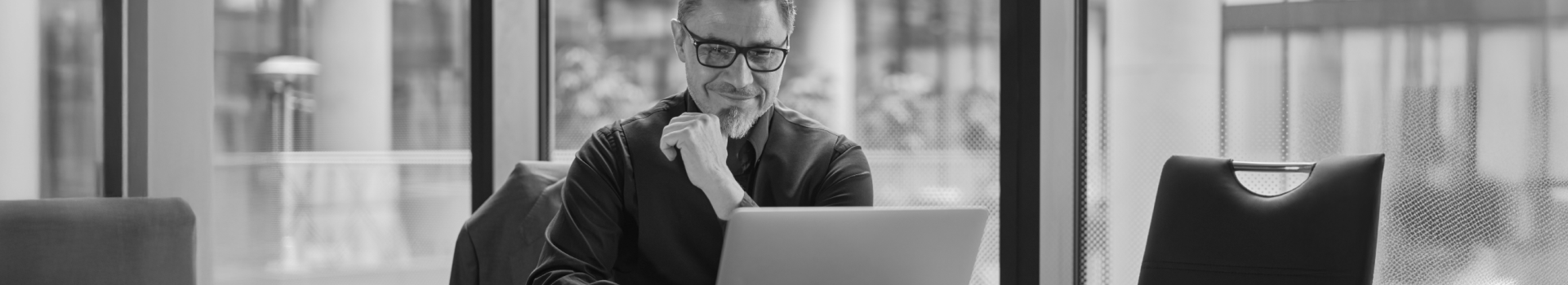 A man with a laptop using cloud-based investment platform