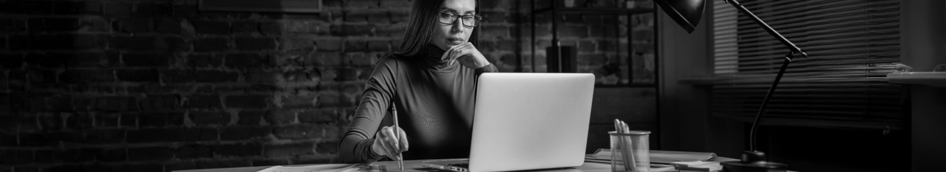 A woman with laptop using cloud-based investment platform