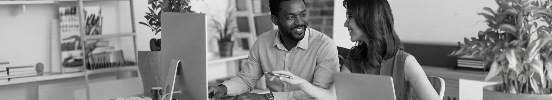 A man and a woman at the computers