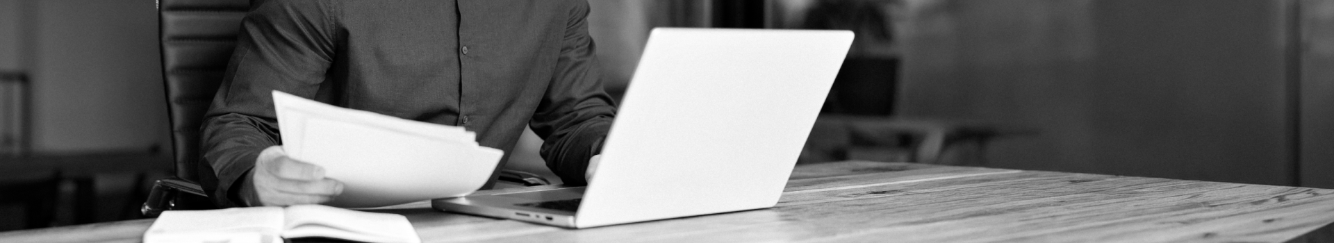 A man with a laptop using AI-powered generator for contractual documentation